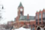 blurred view toward Collingwood's well known town hall, in winter, with snow flakes focused in the foreground