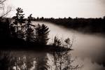 mist rolling around an island in twelve mile bay of the Muskoka Region Ontario